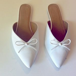 ASOS white flat mule slippers.